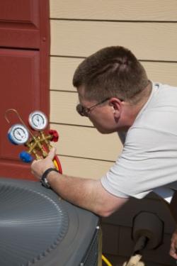 a plumber is checking the refrigerant on an AC unit