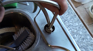 one of our plumbers is installing a new faucet