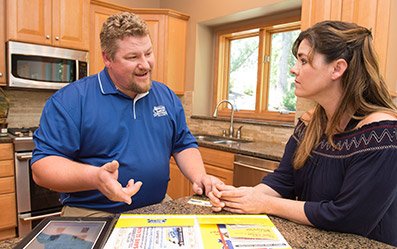 one of our plumbers is handing a price estimate to the client